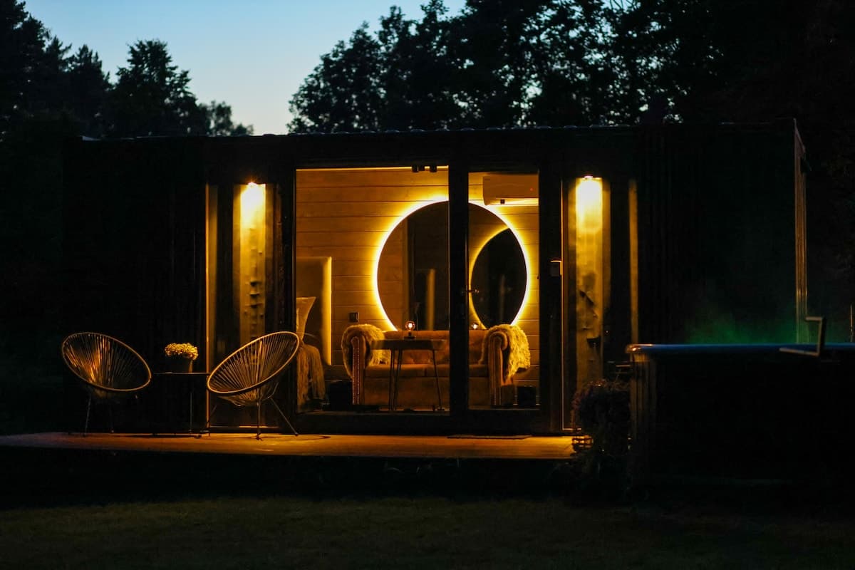 Cozy interior with lounge, bed, and panoramic window